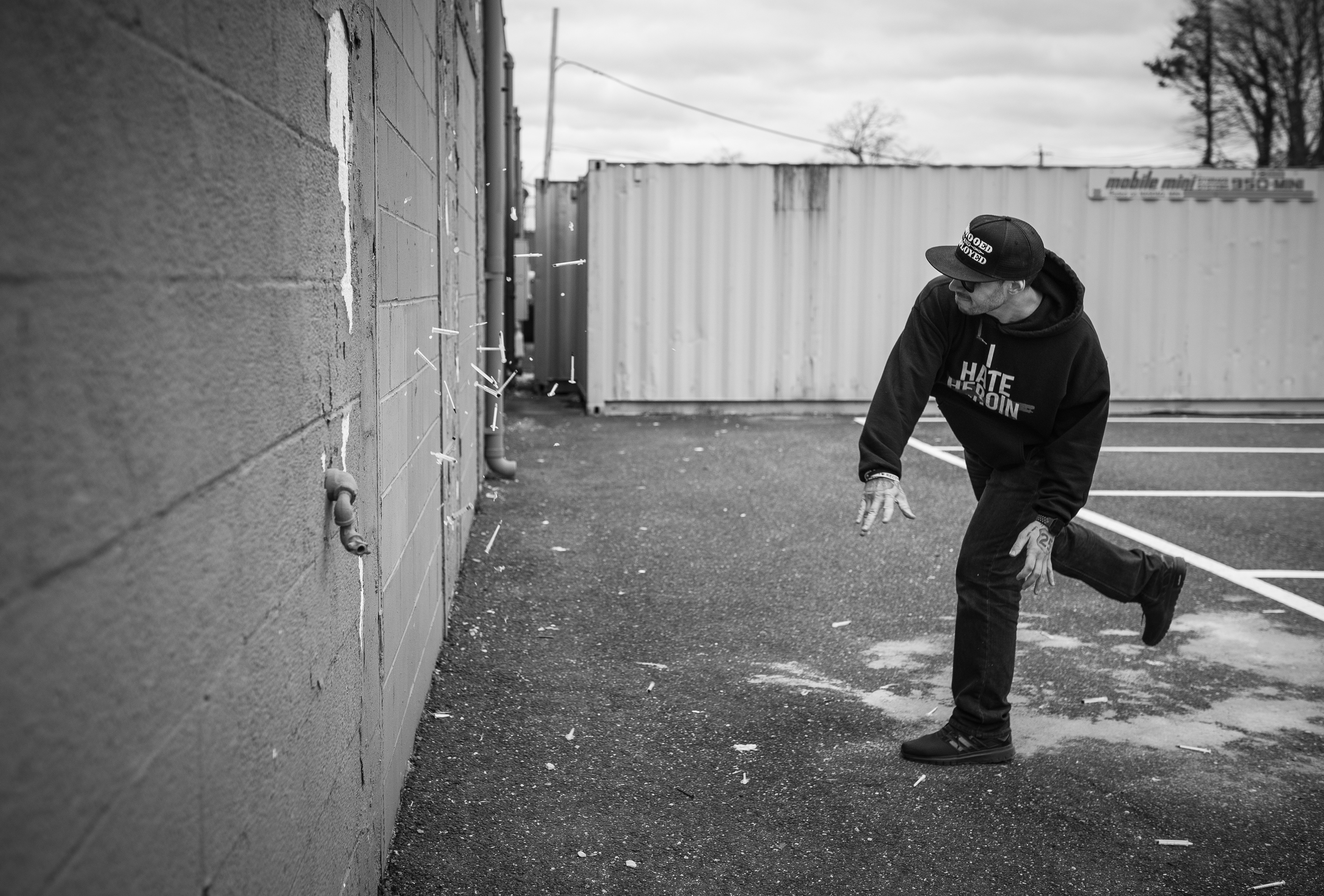 Paul Maffetone of Mattituck, NY, shatters a number of syringes against a brick wall in memory of his brother, Michael, who lost his battle to heroin addiction. This photograph was captured as part of “Stronger Than Syringes,” a photographic essay by Daniel Palumbo.