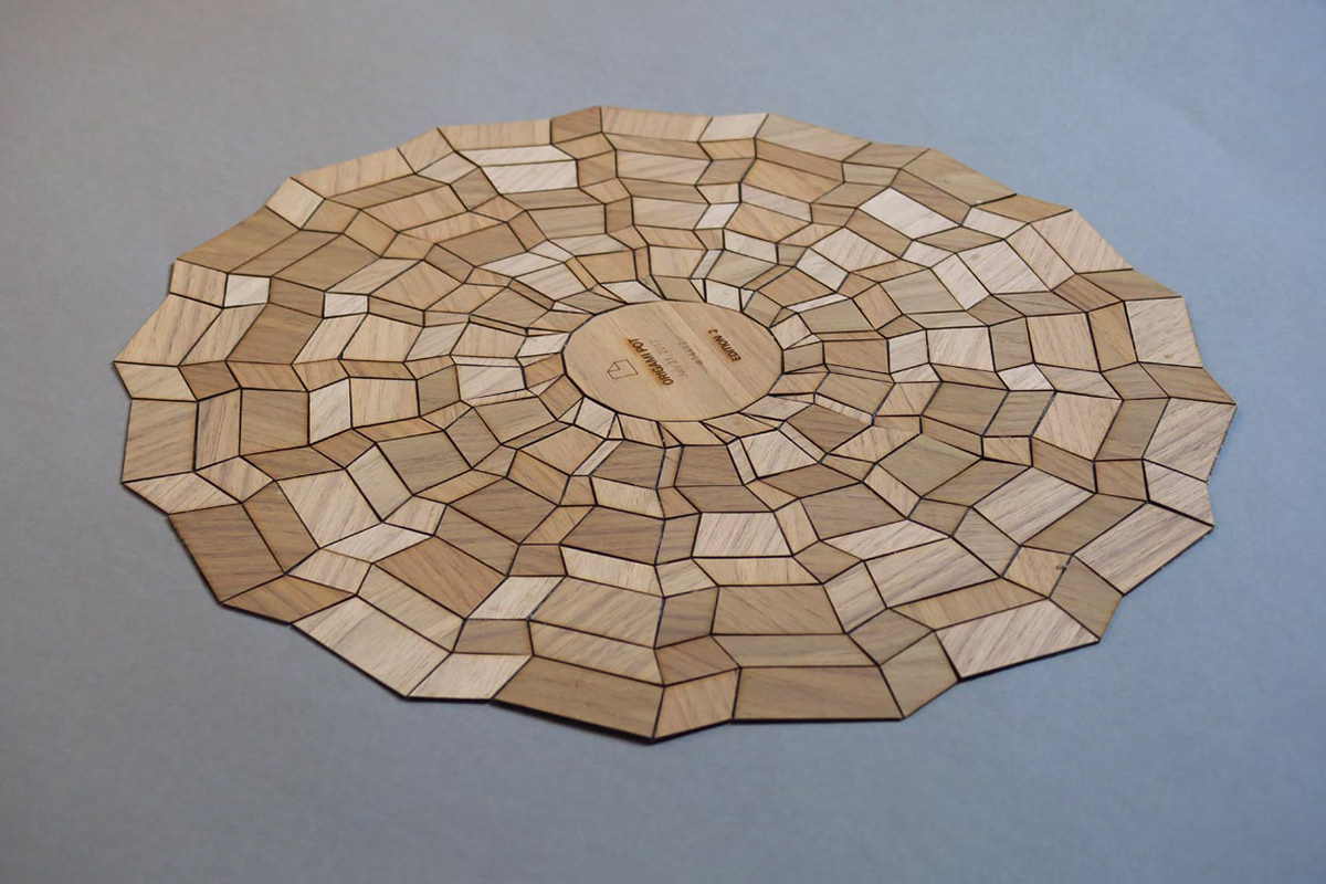 Foldable wooden bowl made of lasered wood with textile composite.