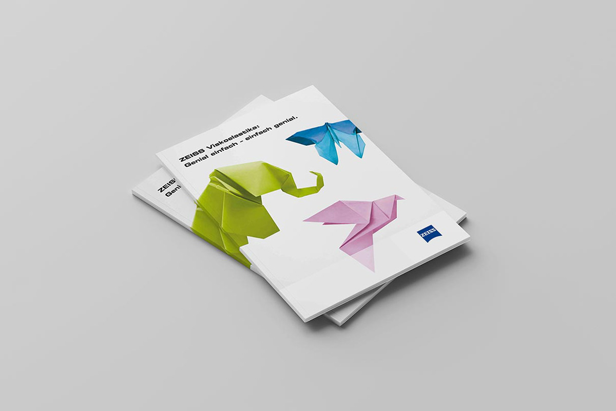 Brochure with a cover illustration of a blue butterfly, a pink dove and a green elephant.