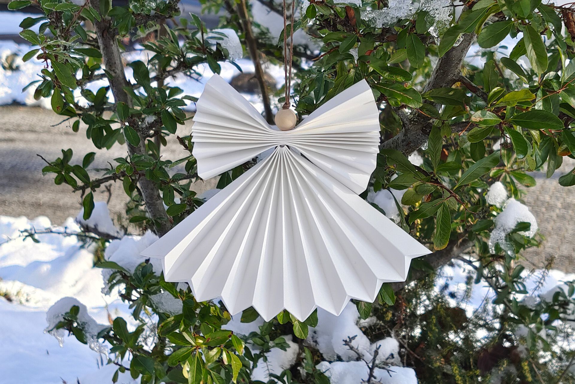 Outdoor origami decoration, Angel pendant out of waterproof origami paper.