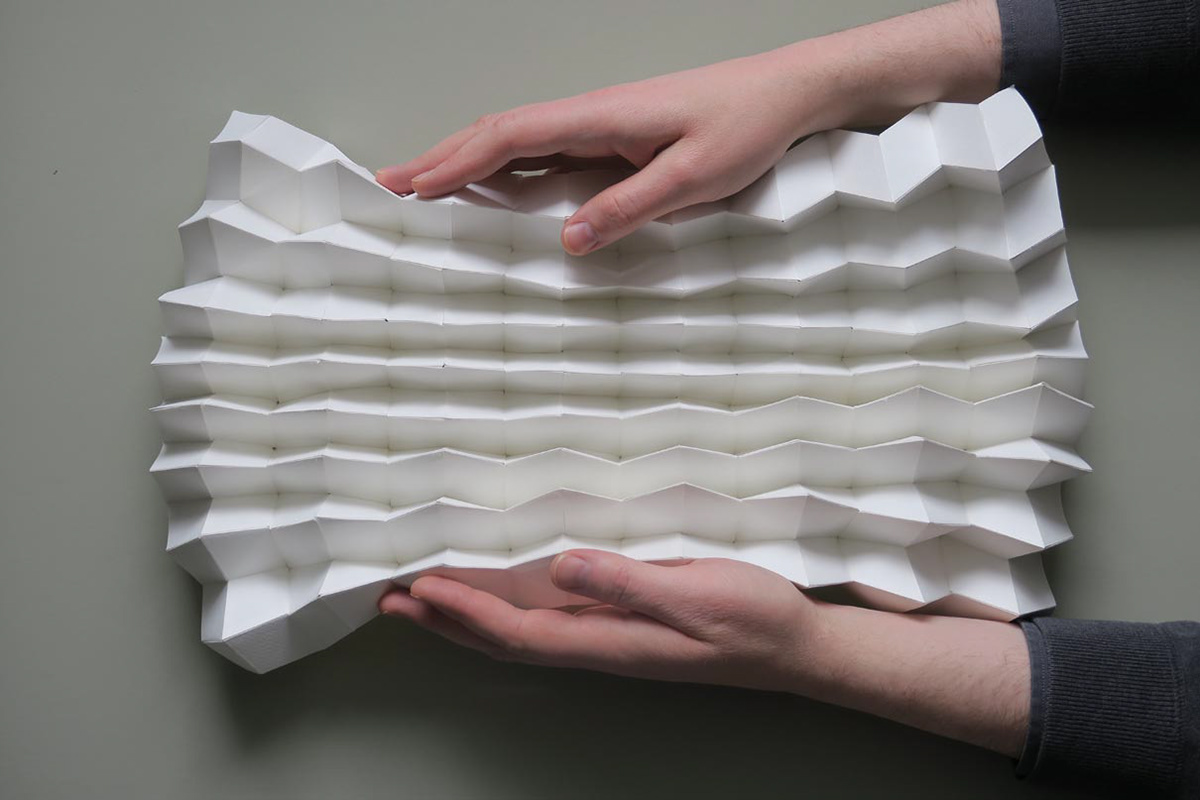 Origami folding structure made of paper that expands or shrinks when pulled apart and compressed.