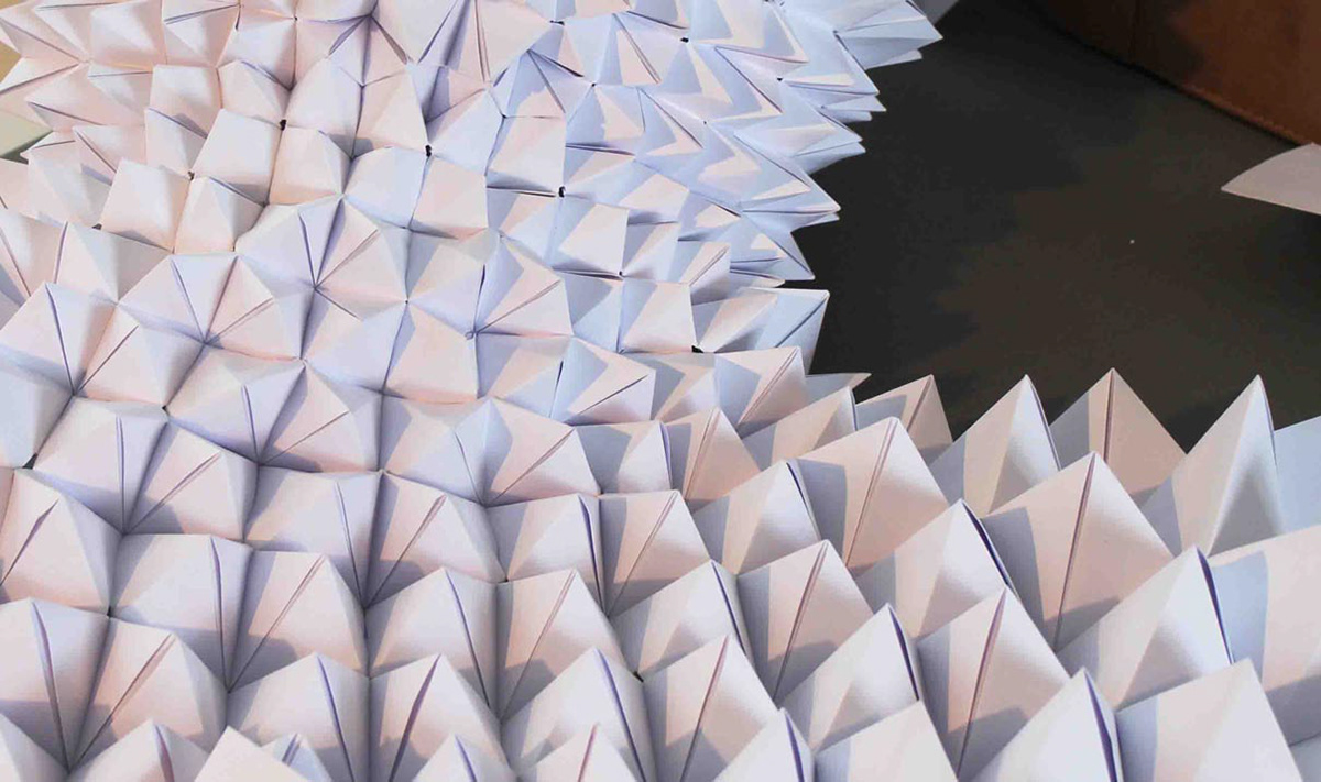 Cloak made from individual origami paper modules.