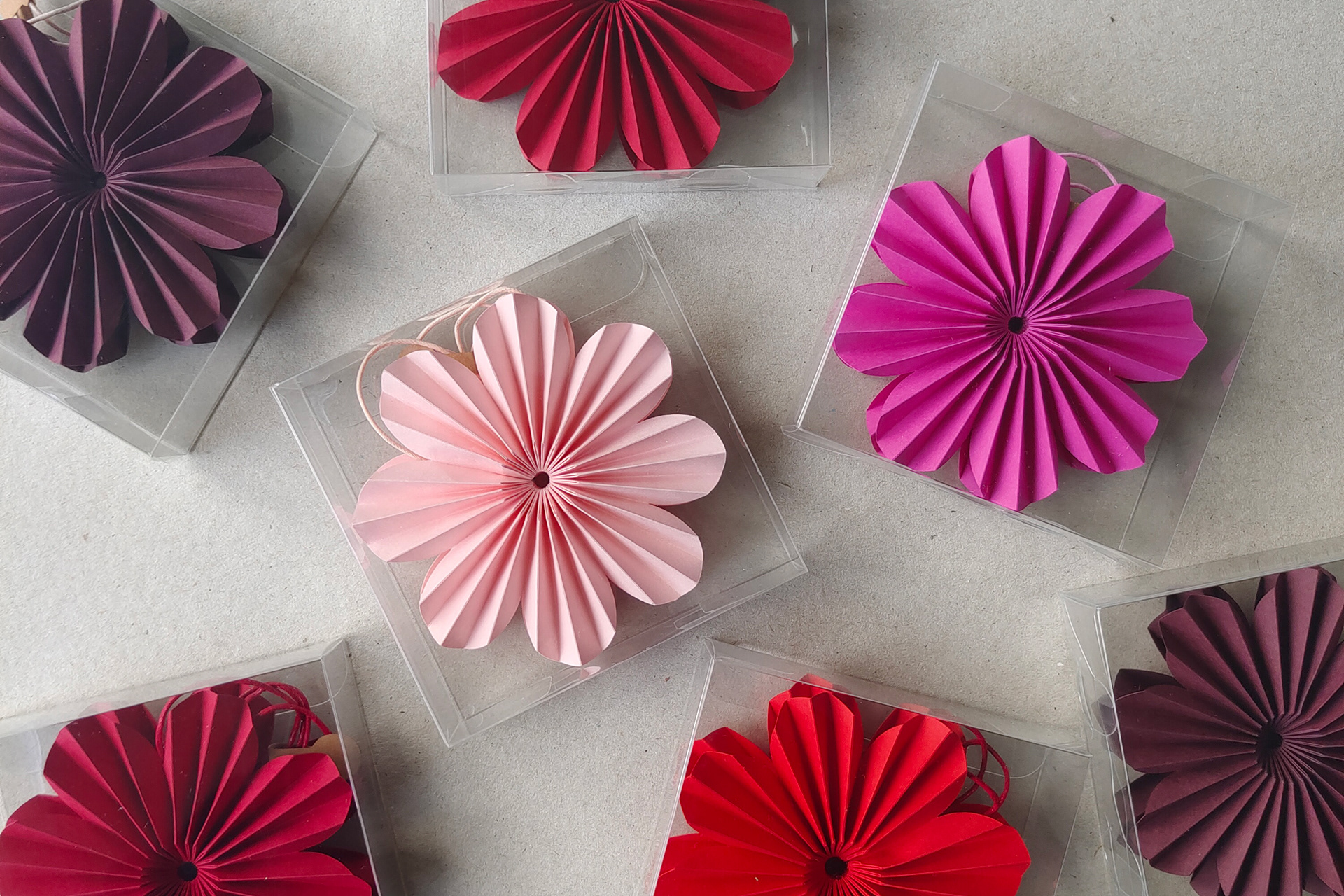 Origami Flower Pendant with transparent packaging, perfect as a gift. Design and handfolded by Kristina Wissling.