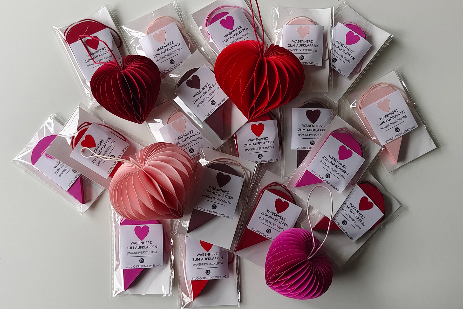 Honeycomb Paper Heart Pendant in different sizes and different shades of red. Perfect as a gift for your loved ones.