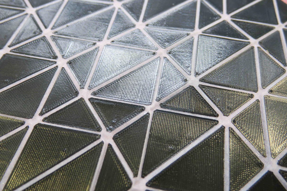 Origami folding structure made from a combination of textile and 3D printing.