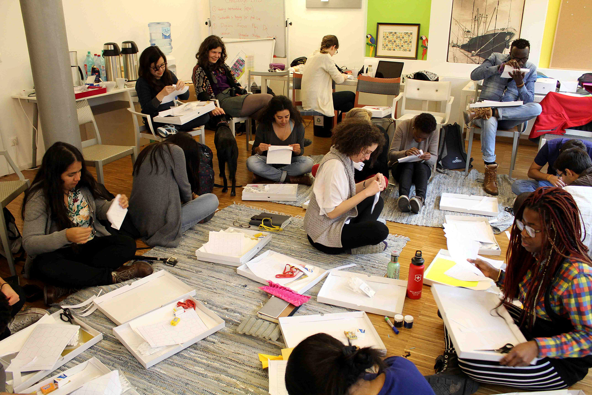 Students of the DoSchool creating paper models using origami folding techniques and Kristina Wißling.