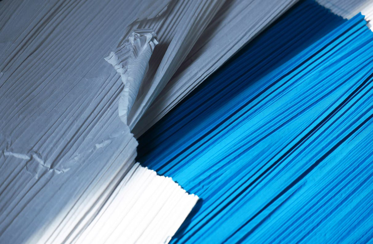 Blue synthetic textile and paper machine pleated using special machines and heat.
