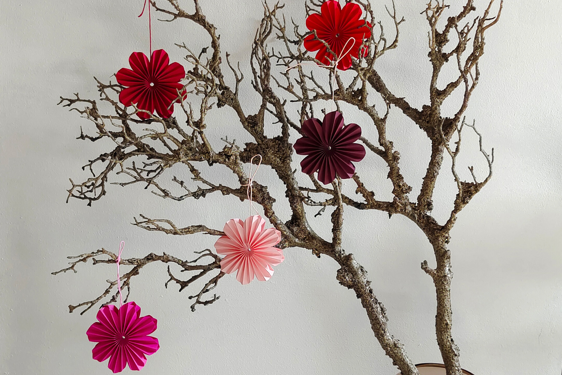 Five Origami Flower Pendant, perfect for spring and summer decoration. Design and handfolded by Kristina Wißling.