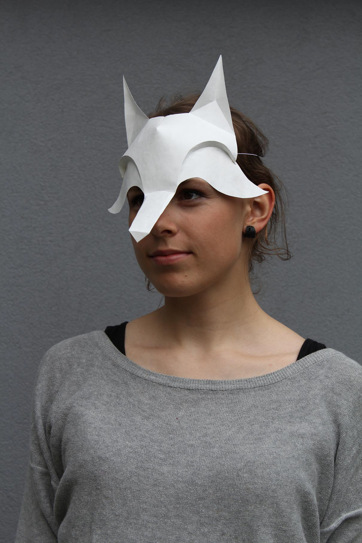 Student with her design - a mask made of paper during the workshop at Burg Giebichenstein with Kristina Wißling on folding techniques.