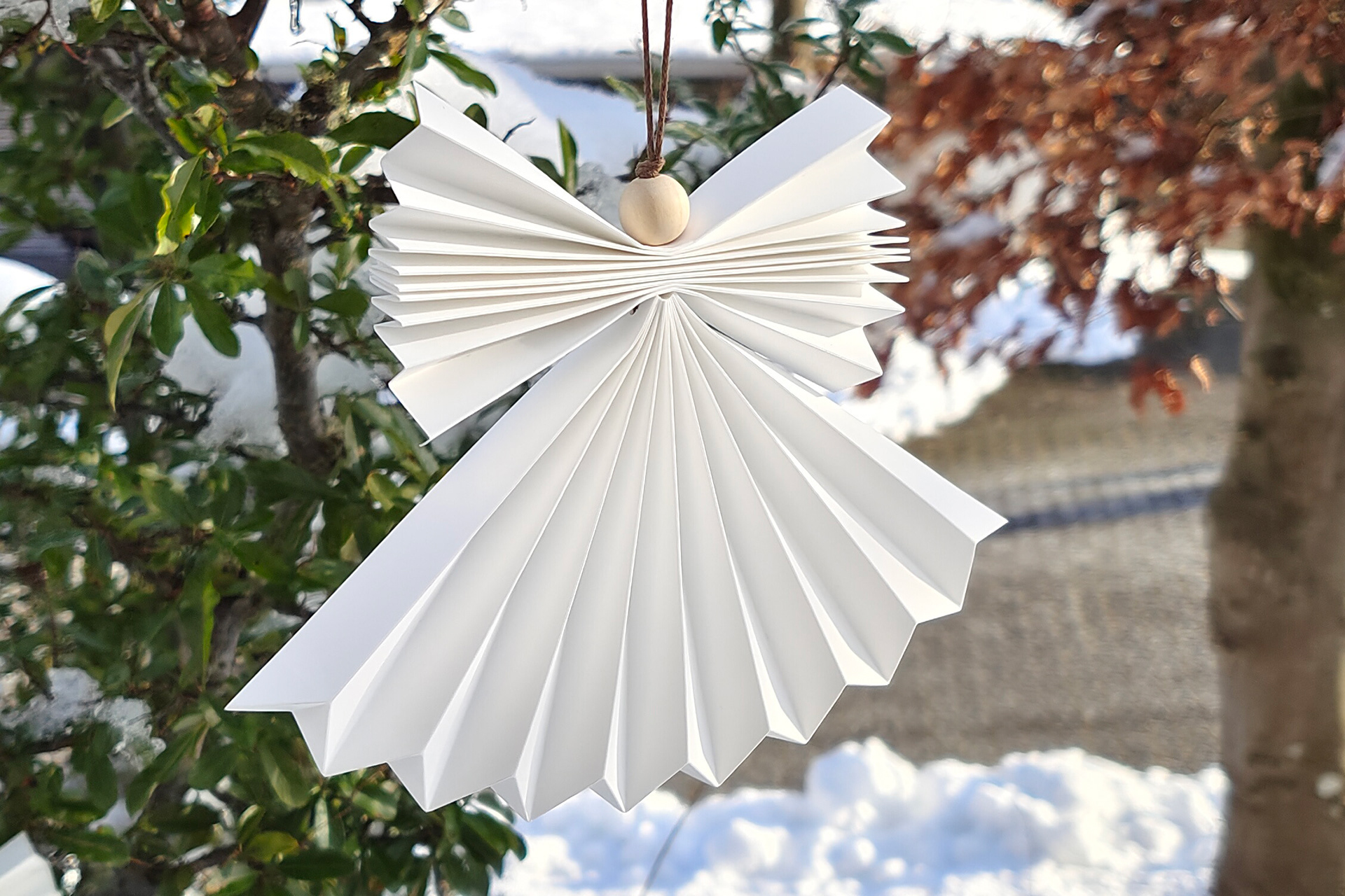 Outdoor Origami Angel pendant, handmade out of waterproof paper. Designer Kristina Wissling.