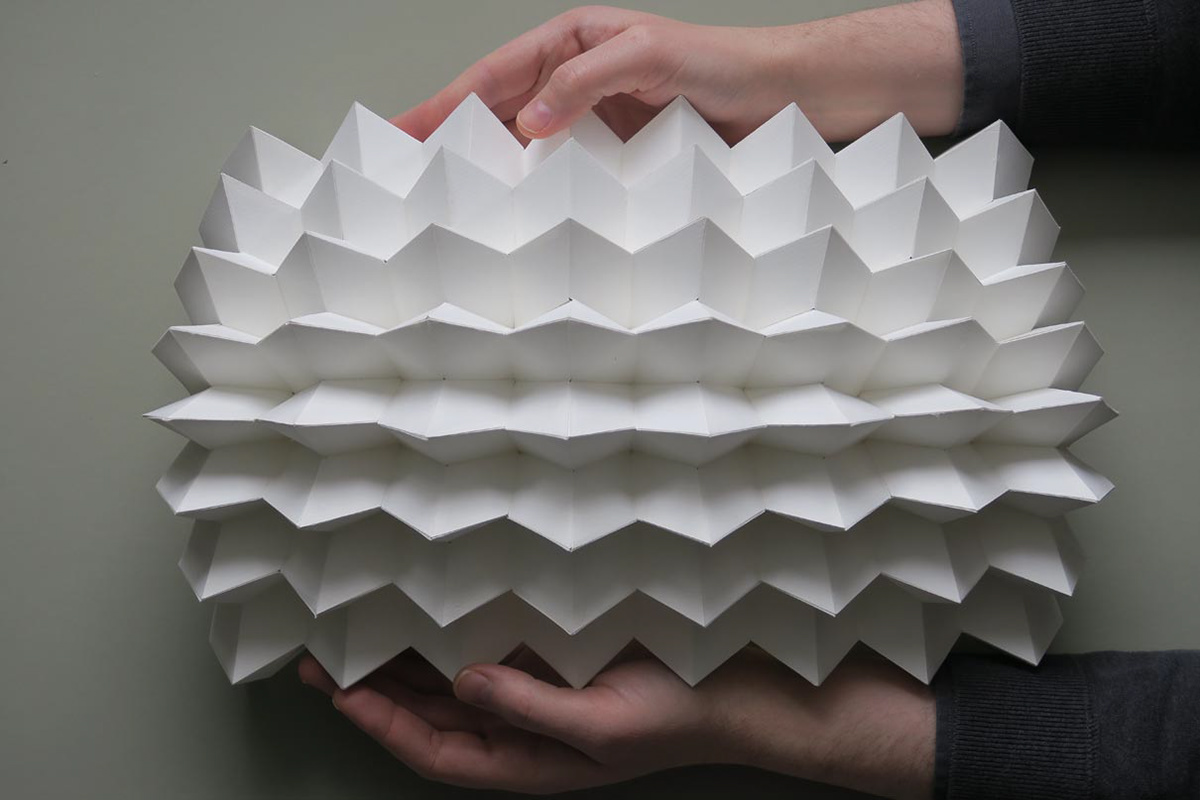 Origami folding structure made of paper that expands or shrinks when pulled apart and compressed.