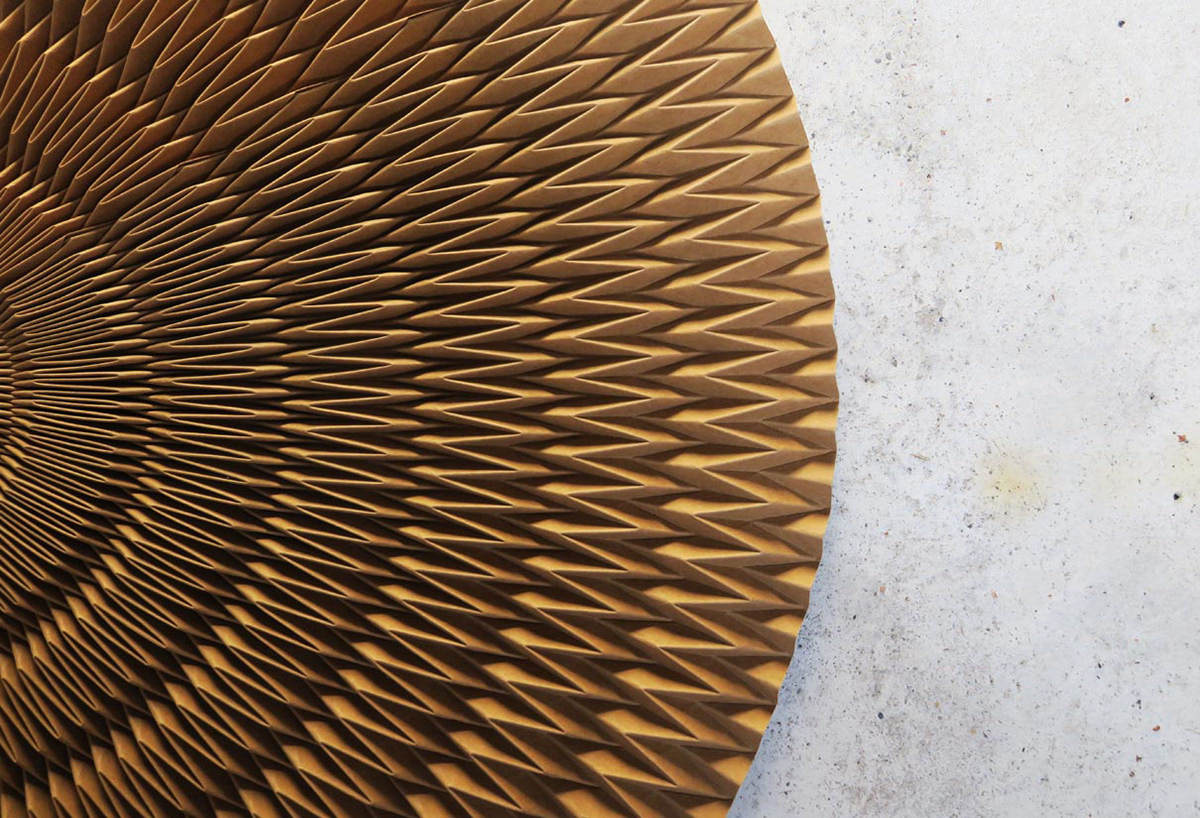Large origami folding structure made of vegan leather for window displays and set design.