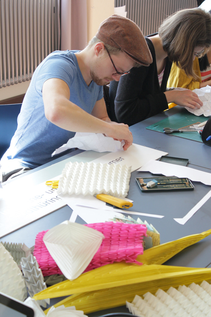 Student during Kristina Wißling's workshop on origami and folding techniques in industrial design.