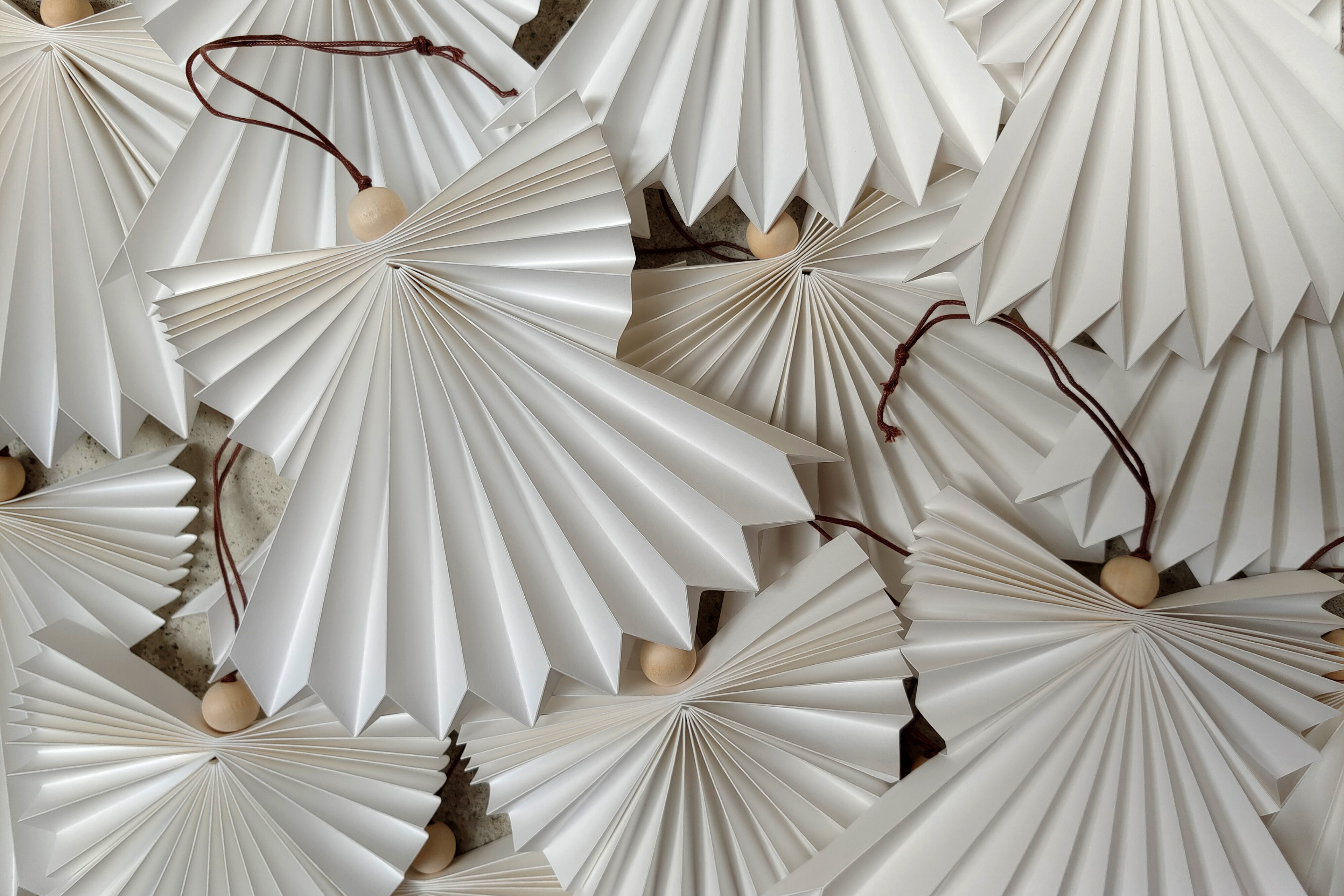 White pleated paper angels, folded by hand, an ideal gift for Christmas..
