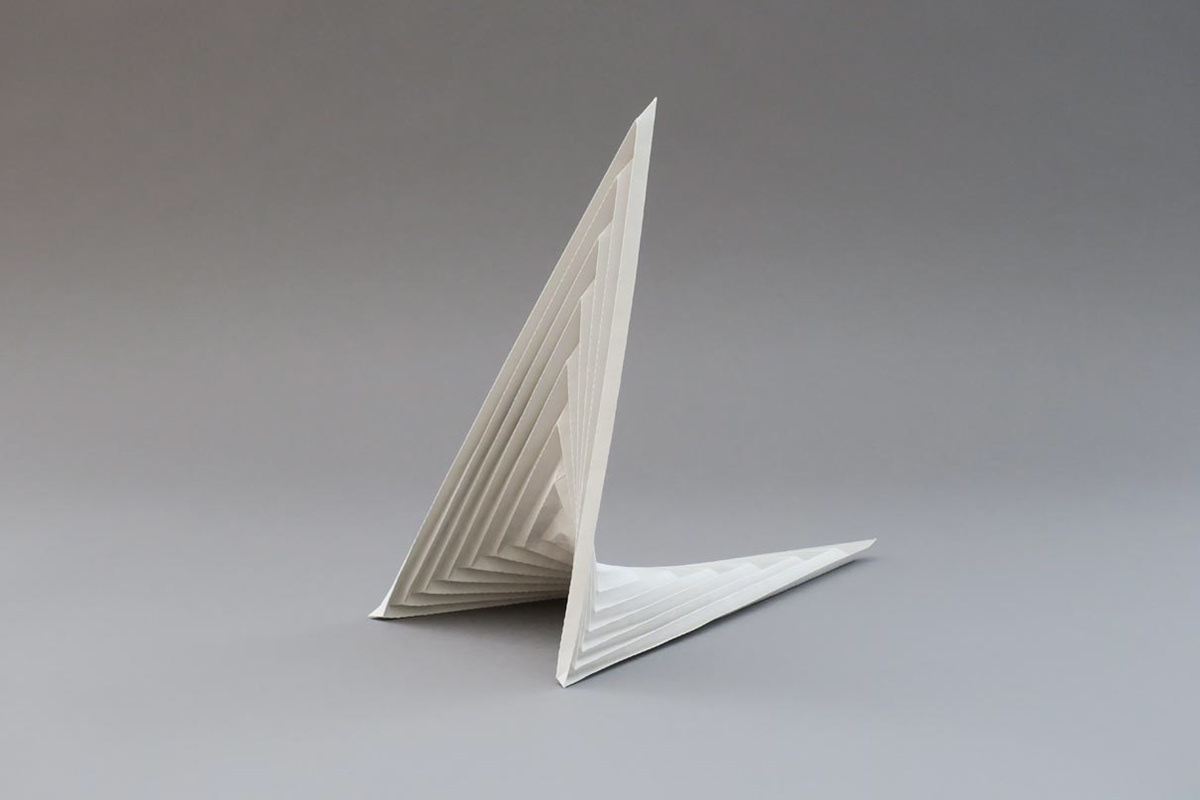 Modified saddle surface made of grey paper for the design of a concrete bridge.