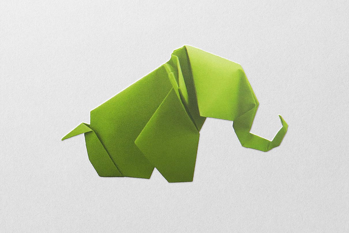 Image of a green origami elephant for a cover illustration.