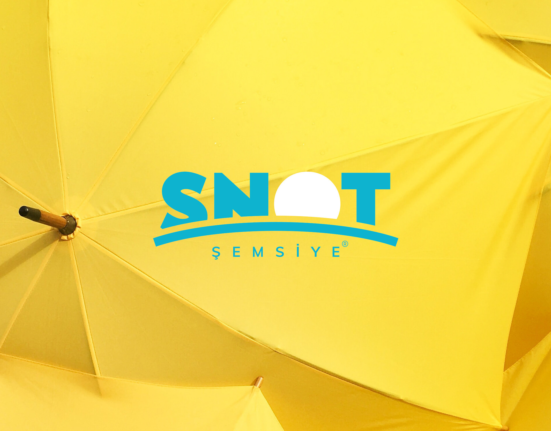 Snot Şemsiye logo on yellow commercial umbrellas, brand identity redesign
