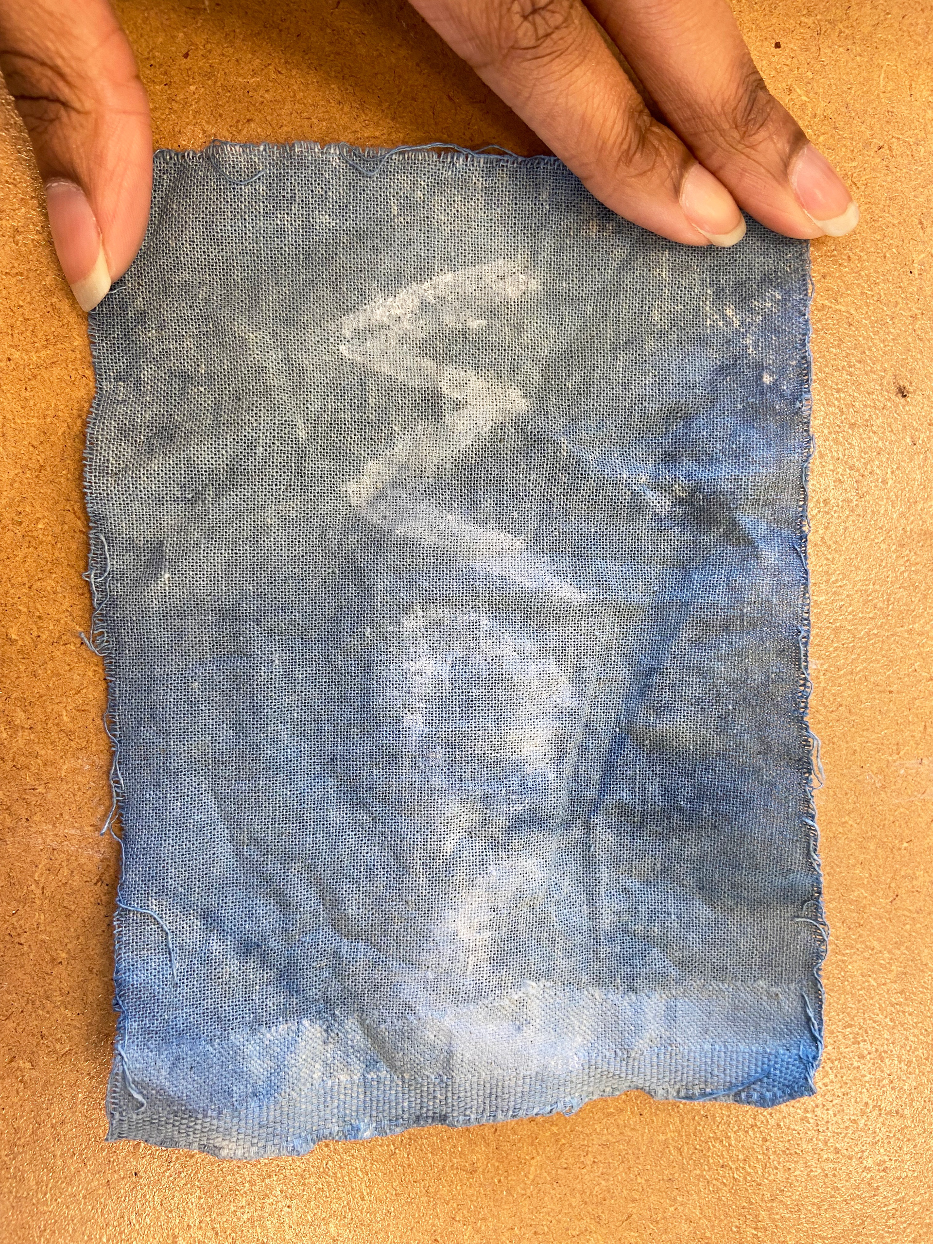 Glue resist on dyed fabric
