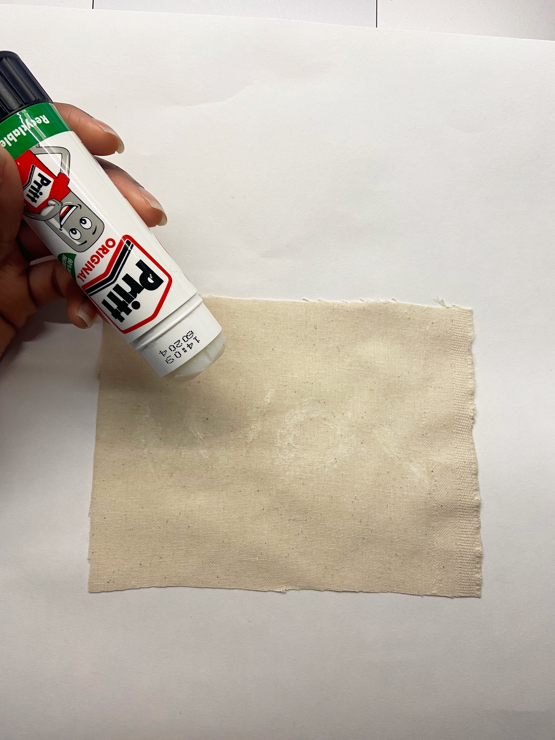 Using glue as a resist method to write on fabric