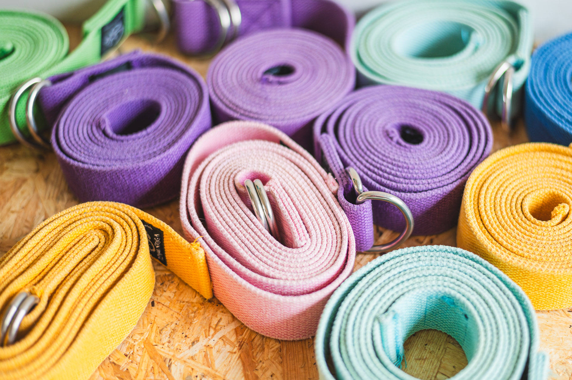 Colorful rolled yoga straps, studio detail for yoga brand photography