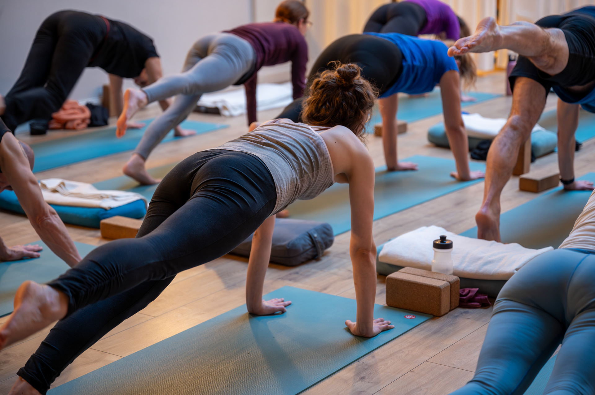 Students in a plank variation with cork blocks and bolsters