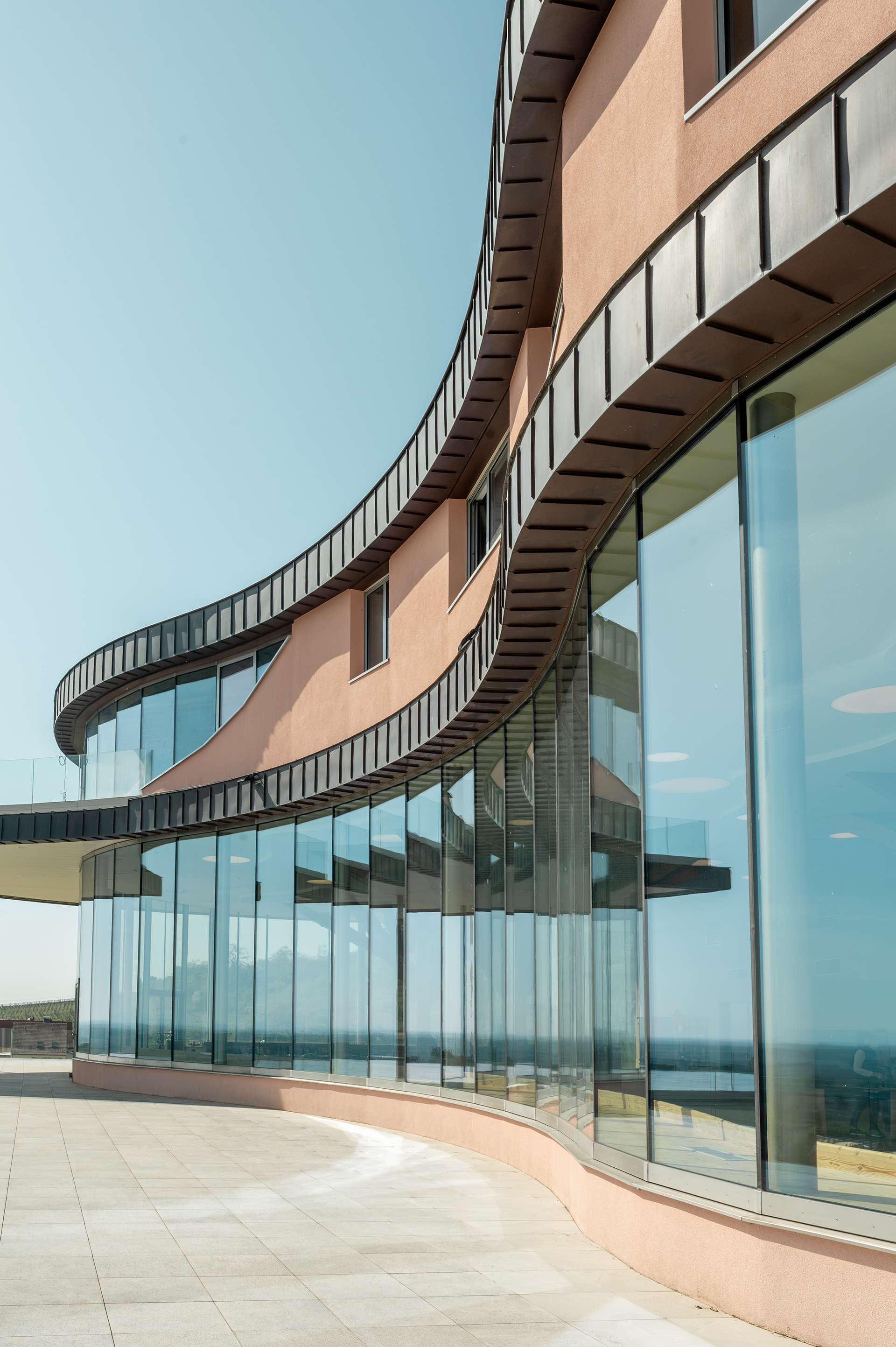 Curved glass facade of the Rolly Gassmann wine estate