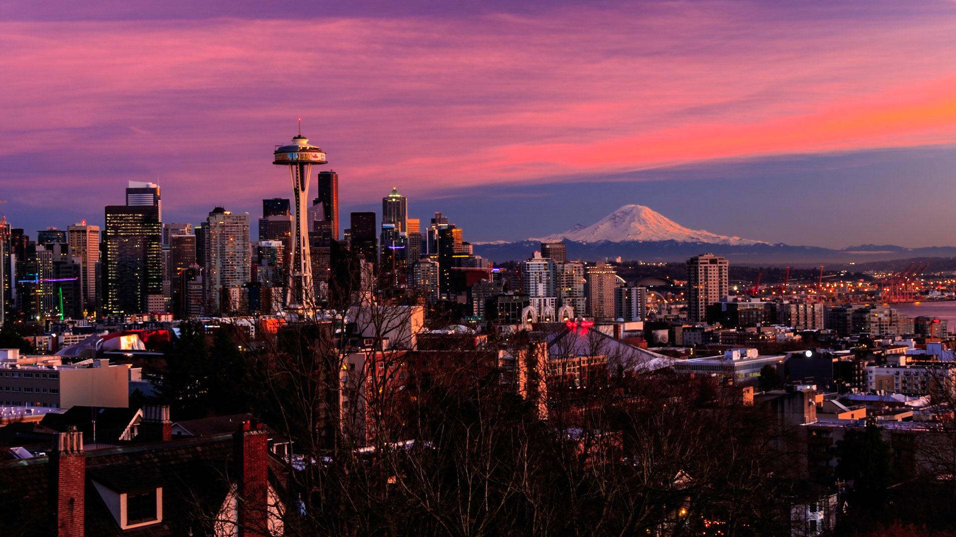 The sky above Seattle takes on a rose color as the sun sets.