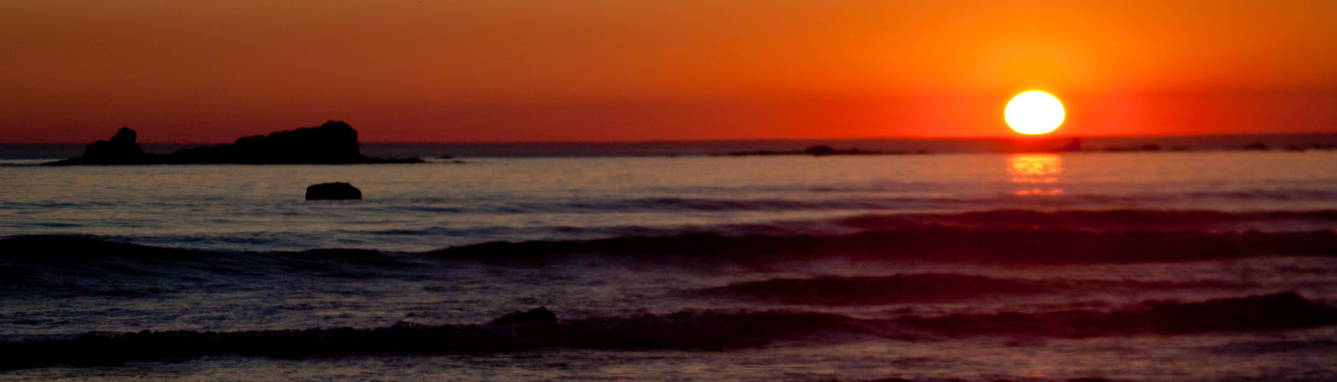 Near Sandpoint in the Lake Ozette Area of Olympic National Park.  There was a forest fire burning on Vancouver Island and the wind was blowing the smoke out to sea. The sunset was... magnificent!