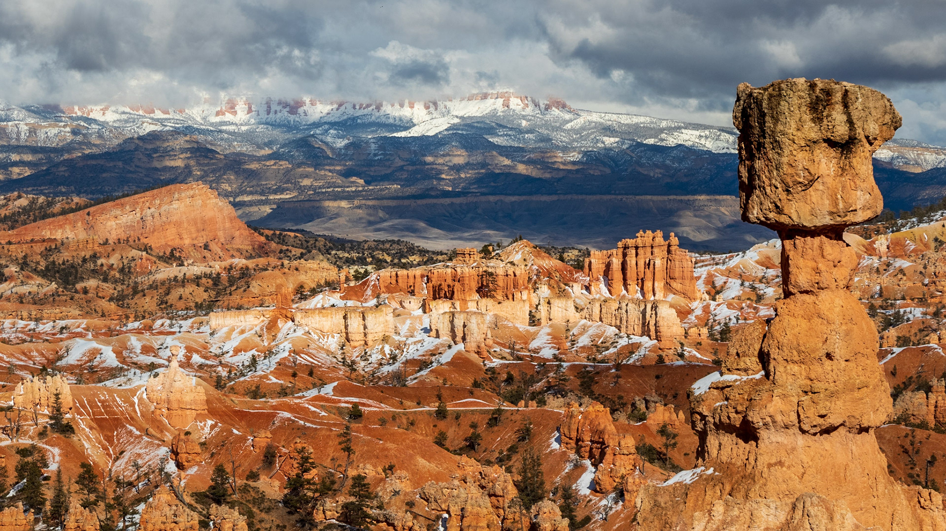 In the background are the mountains of Grand Staircase Escalante National Momument. In the midground on the left is "The Sinking Ship" and in the foreground on the right, "Thor's Hammer"