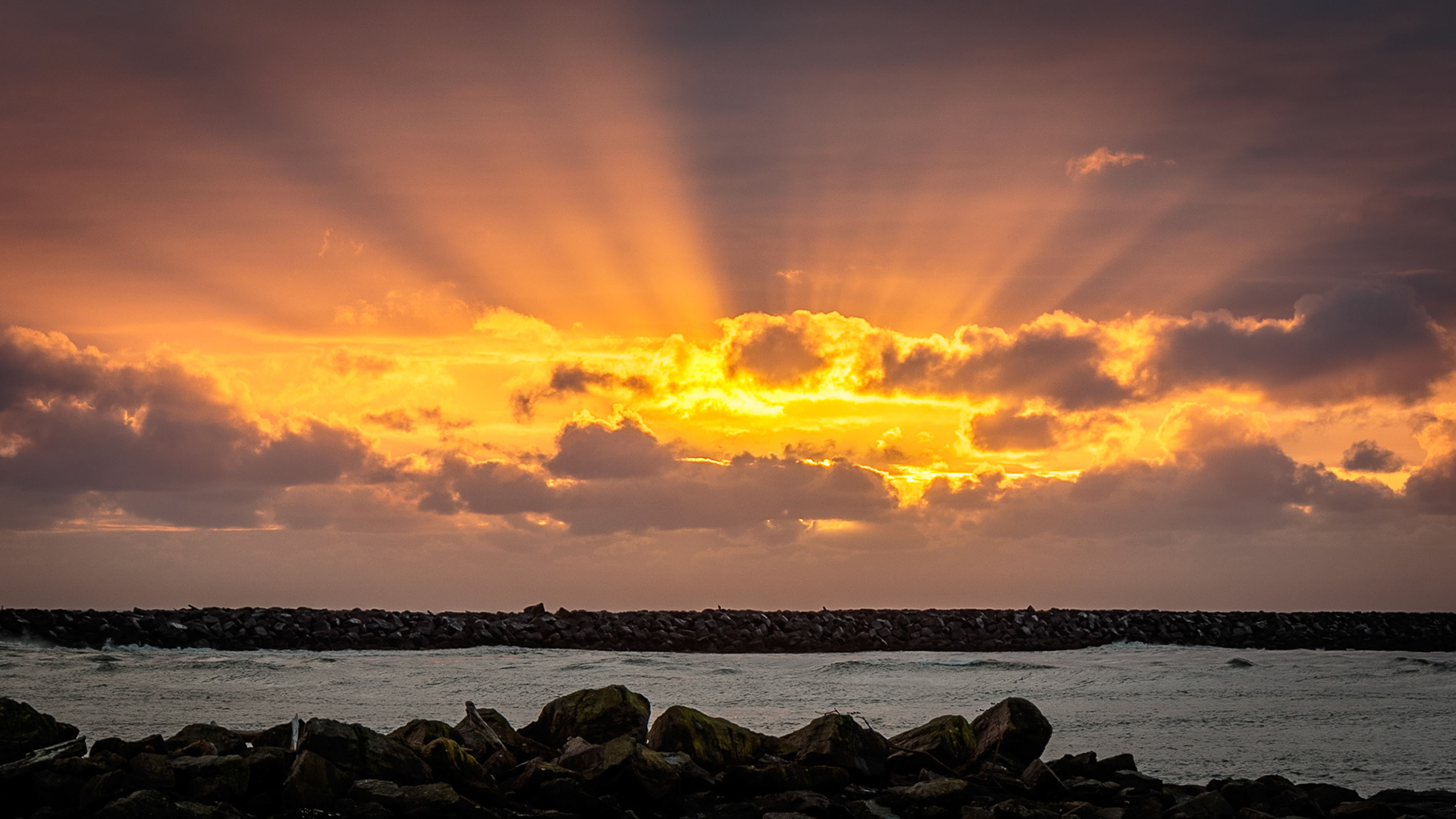 The sun casts an awsome light show over the entrance to Tillamook Bay