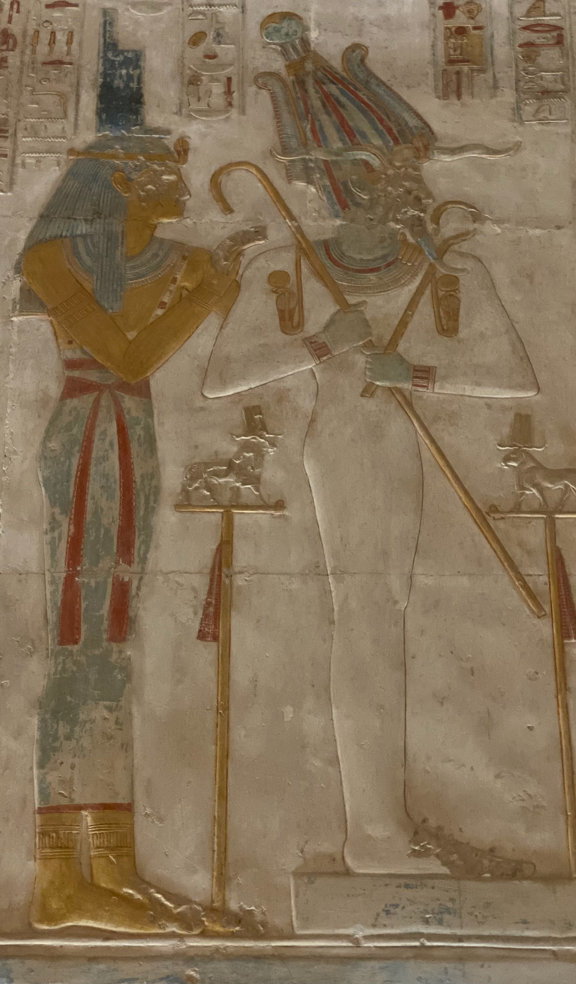 Asir (with Auset behind) on the wall in Seti I Temple, Abydos, Egypt. (Notice he stands upon the foundation of Ma’at!)