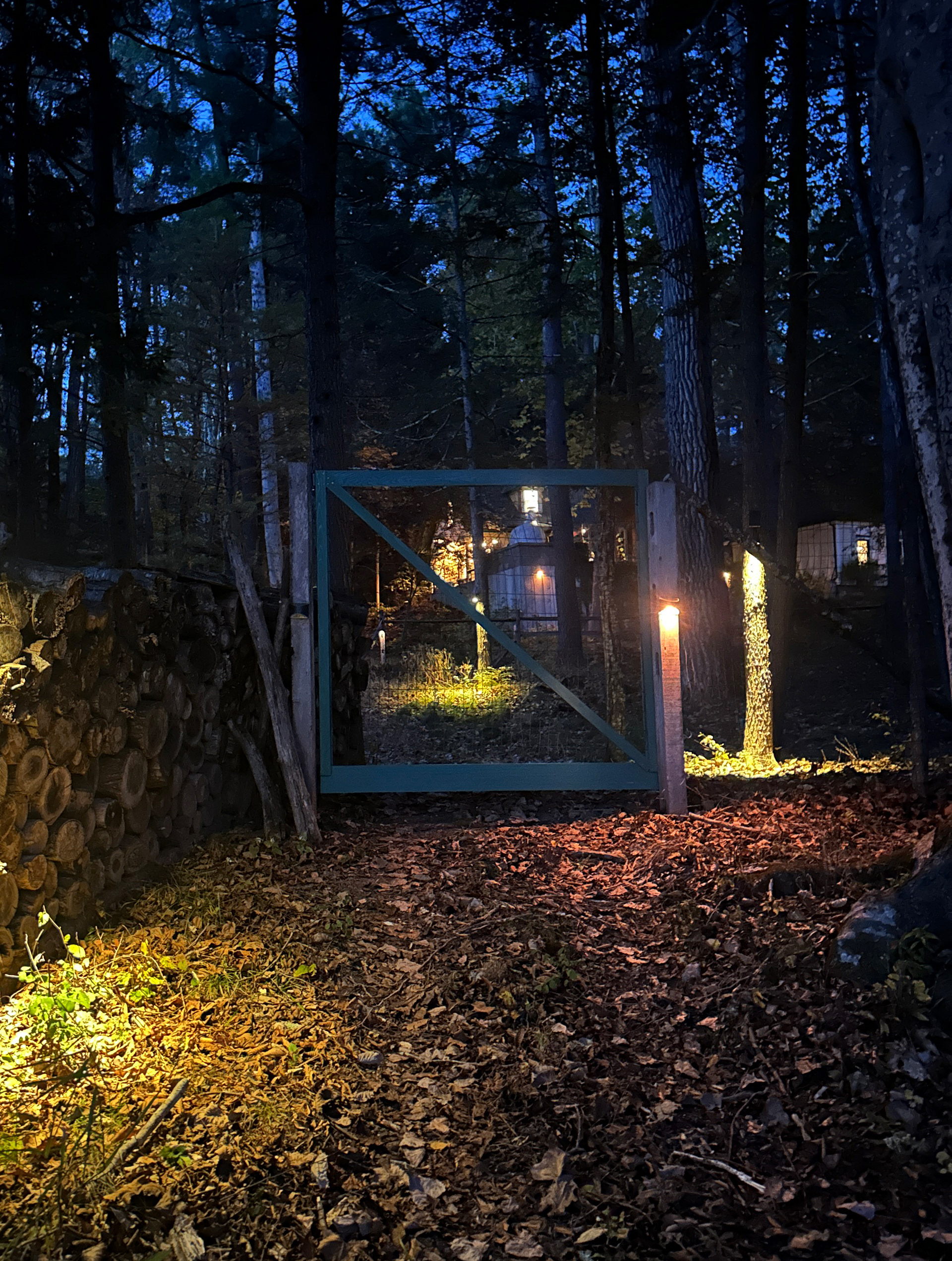 The path from the river to the cottage features lights and a deer gate