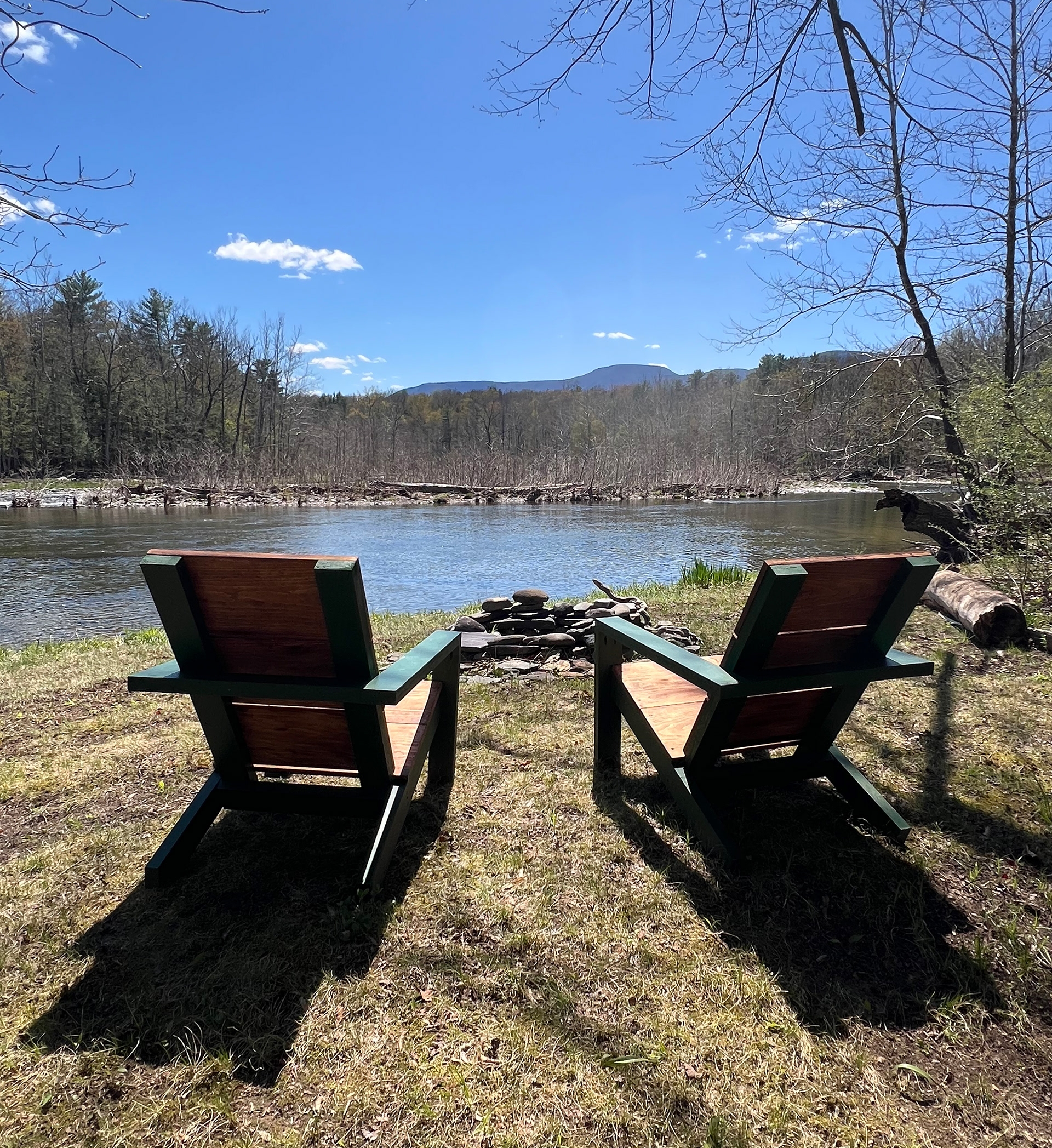 Two home-built Adirondack chairs overlooking the Catskill Creek from the cottage property.