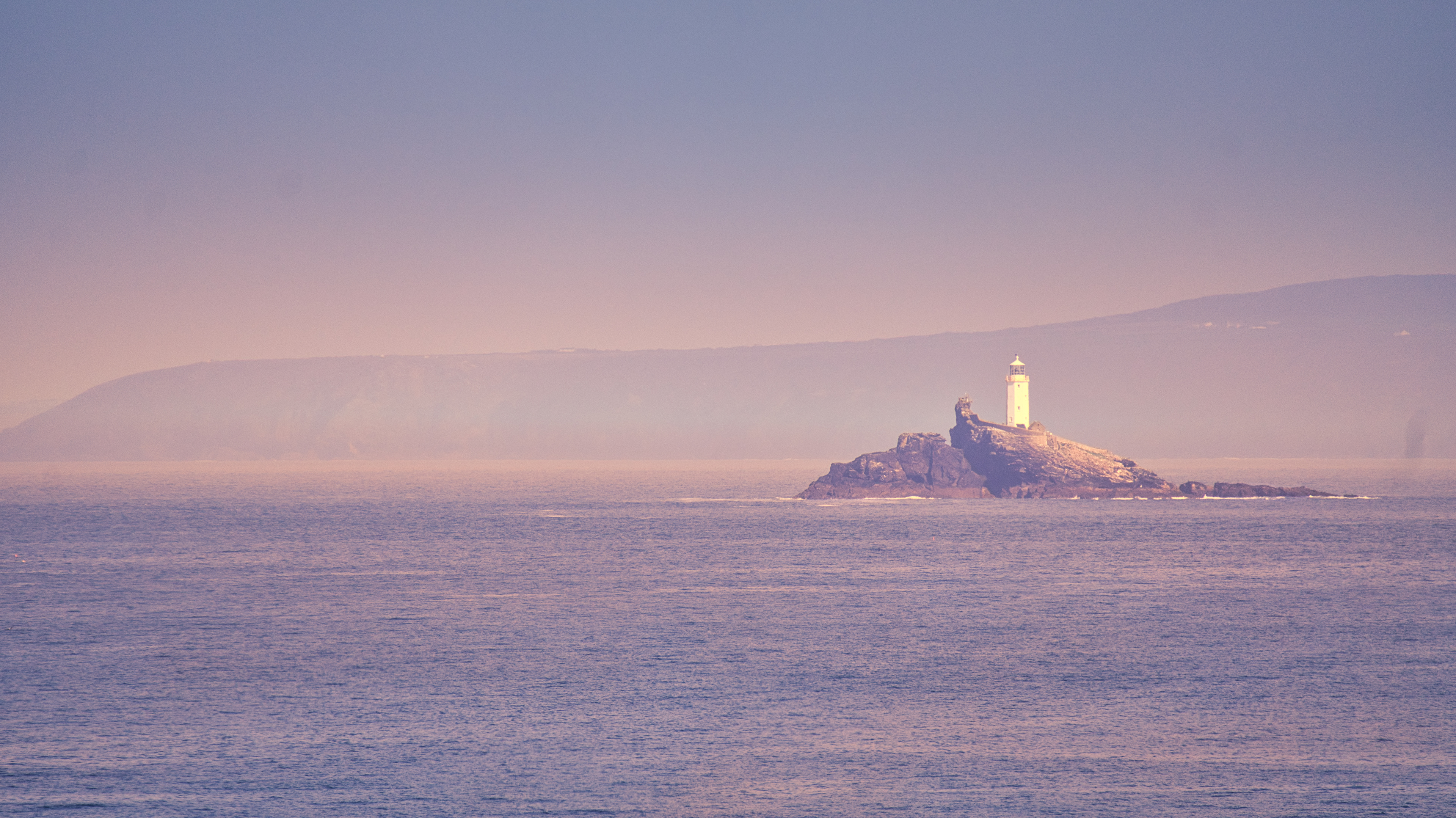Godrevy Lighthouse standing calm in the evening light.