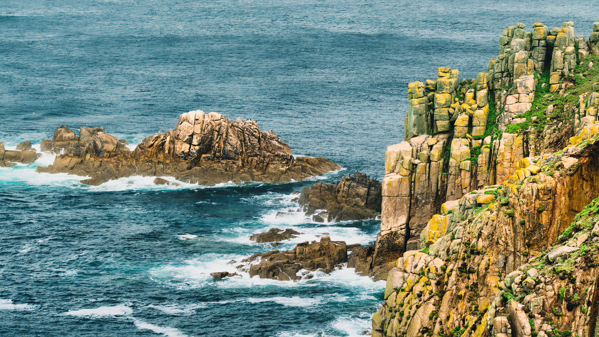 Golden rocks, deep blue waters – a peaceful moment at Land’s End.