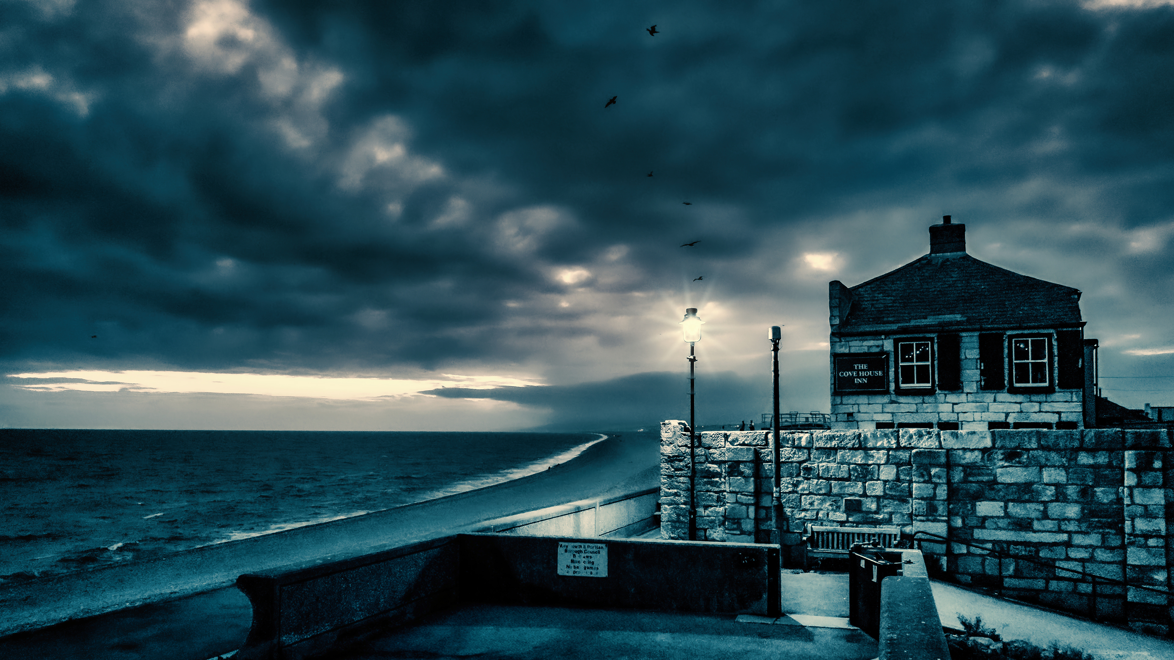 Twilight whispers at Chesil Beach — where the sea meets solitude and the old inn stands watch.