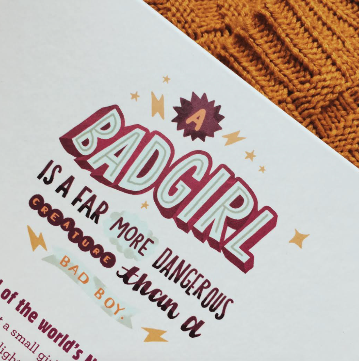 the photo shows a close up of some hand drawing typography that reads "a bad girl is a far more dangerous creature than a bad boy"