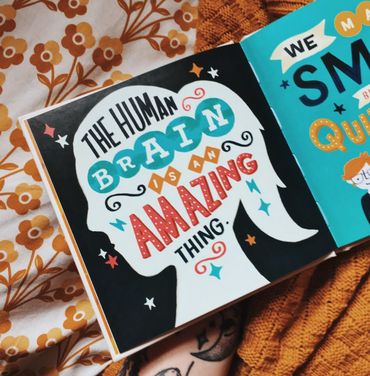 the photo shows a silhouette of a girls head. The text inside reads "the human brain is an amazing thing" the background is a dark navy blue and there are different coloured stars dotted around the page