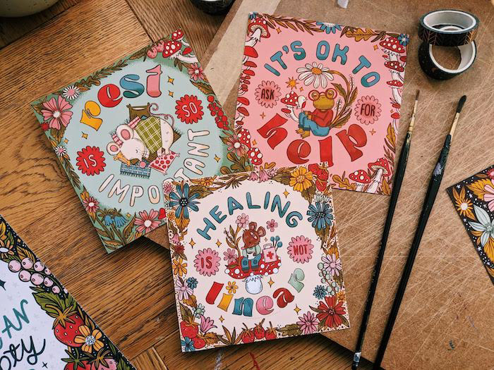 the image shows three colourful prints, each print shows a cute animal surrounded by a floral border. The text reads "rest is so important", "healing is not linear" and "It's ok to ask for help"