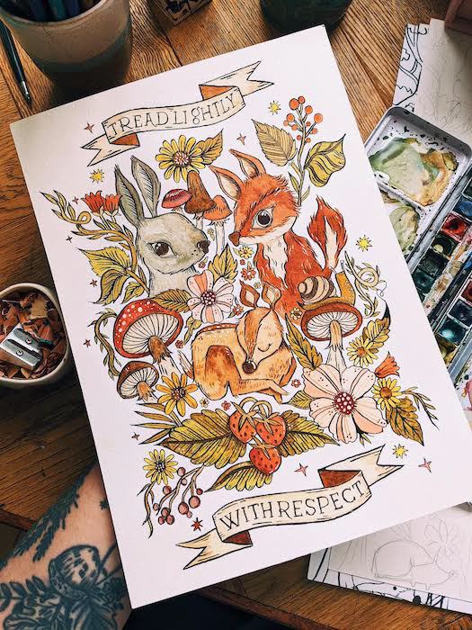 a watercolour painting that shows a rabbit, a fox and a deer surrounded by flowers, leaves, mushrooms and berries. text inside a banner reads "tread lightly, with respect"