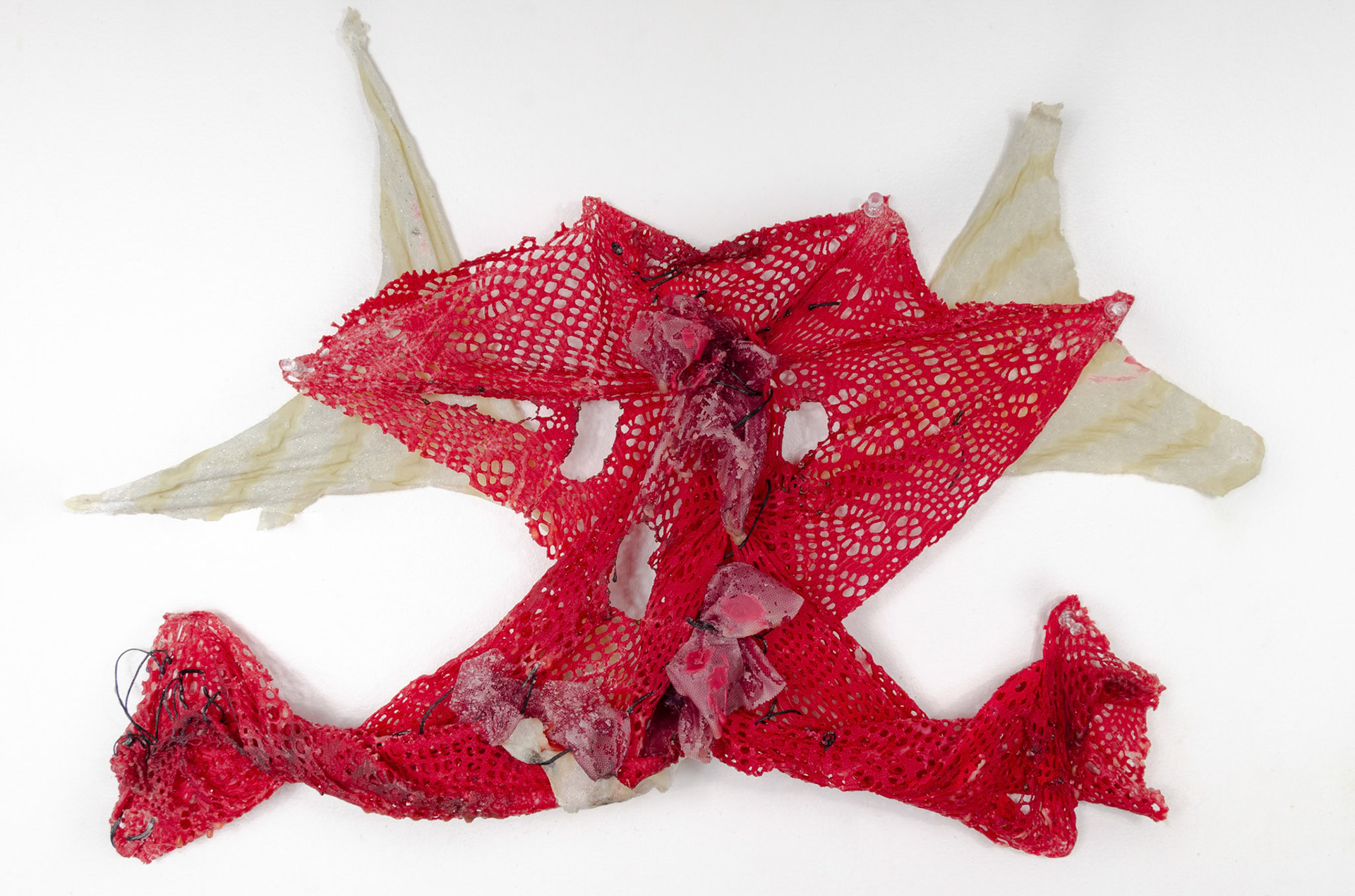 Splayed (2020), 14" x 24". Mixed Fabric, Tulle, Red and White Beeswax, Thread, Fire