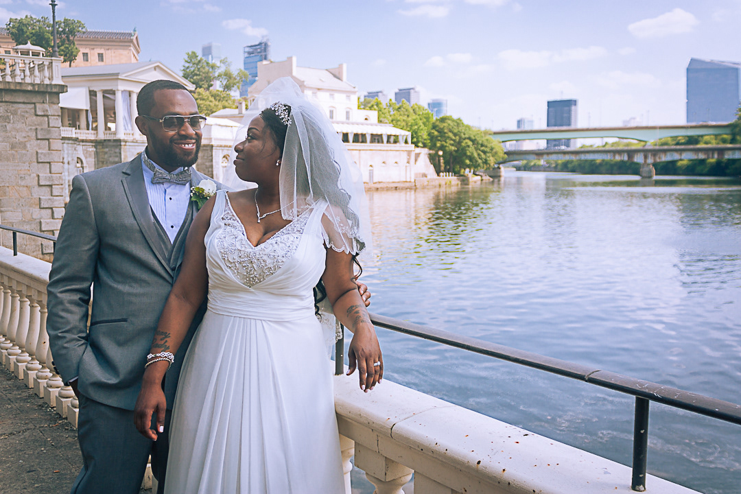 Black African American Bride and Groom in Fairmount Park on the Schuylkill River Behind the Philadelphia Art Museum