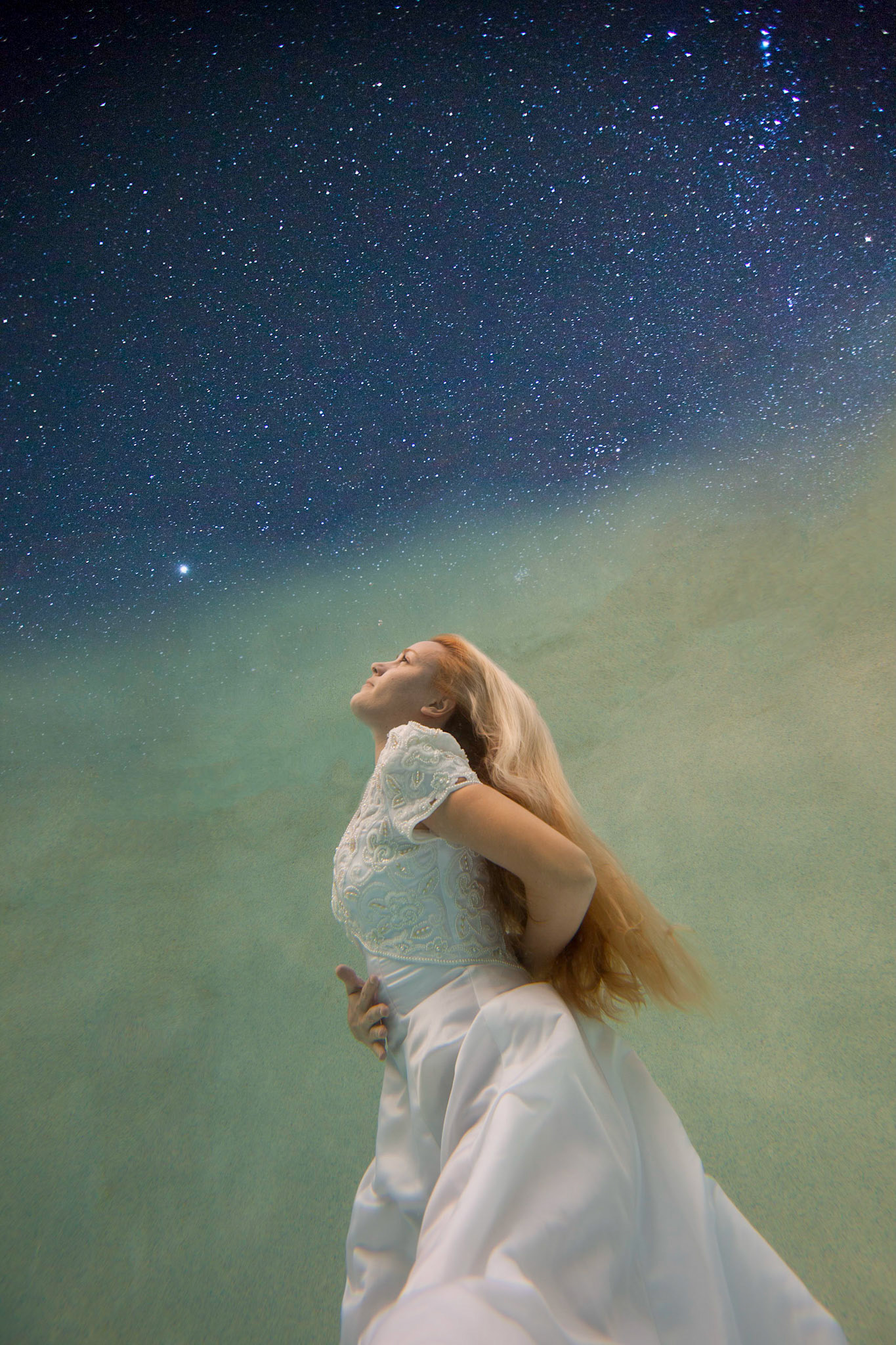 6204-Bridal art trash the dress style.  Rachael in a wedding dress modelling as only she can. This was her first project underwater and she did a fabulous job. We took these images in a pool. In all of these images both Rachael and photographer are underwater.