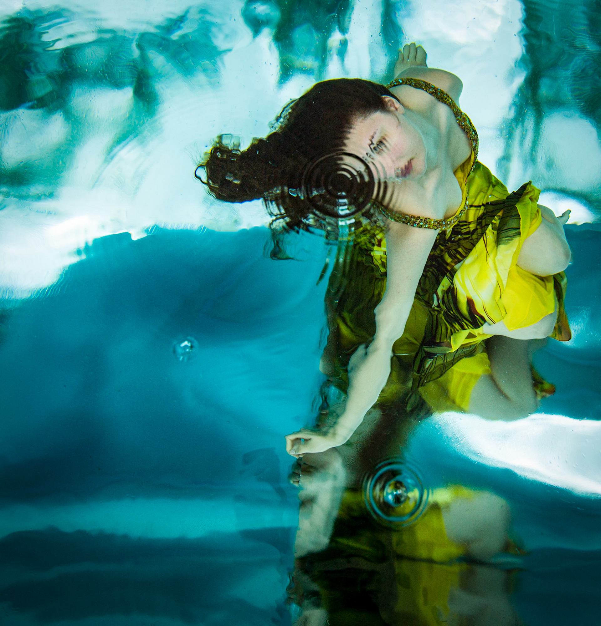 5121-Bridal art, trash the dress style. Brianna in a wedding dress modelling as only she can. This was her first project underwater and she did a fabulous job. We took these images in a pool. In all of these images both Brianna and photographer are underwater.