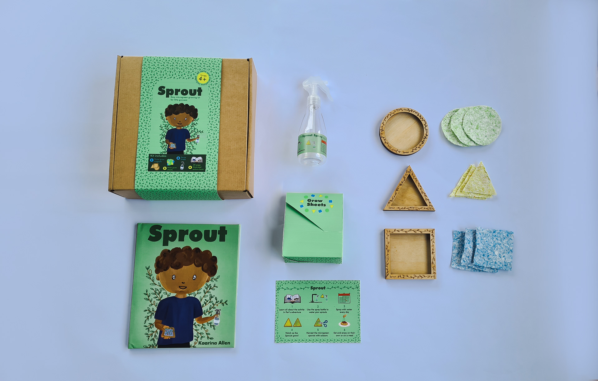 Flat lay of the activity pack featuring the book, grow sheets, spray bottle, magnets and instructions