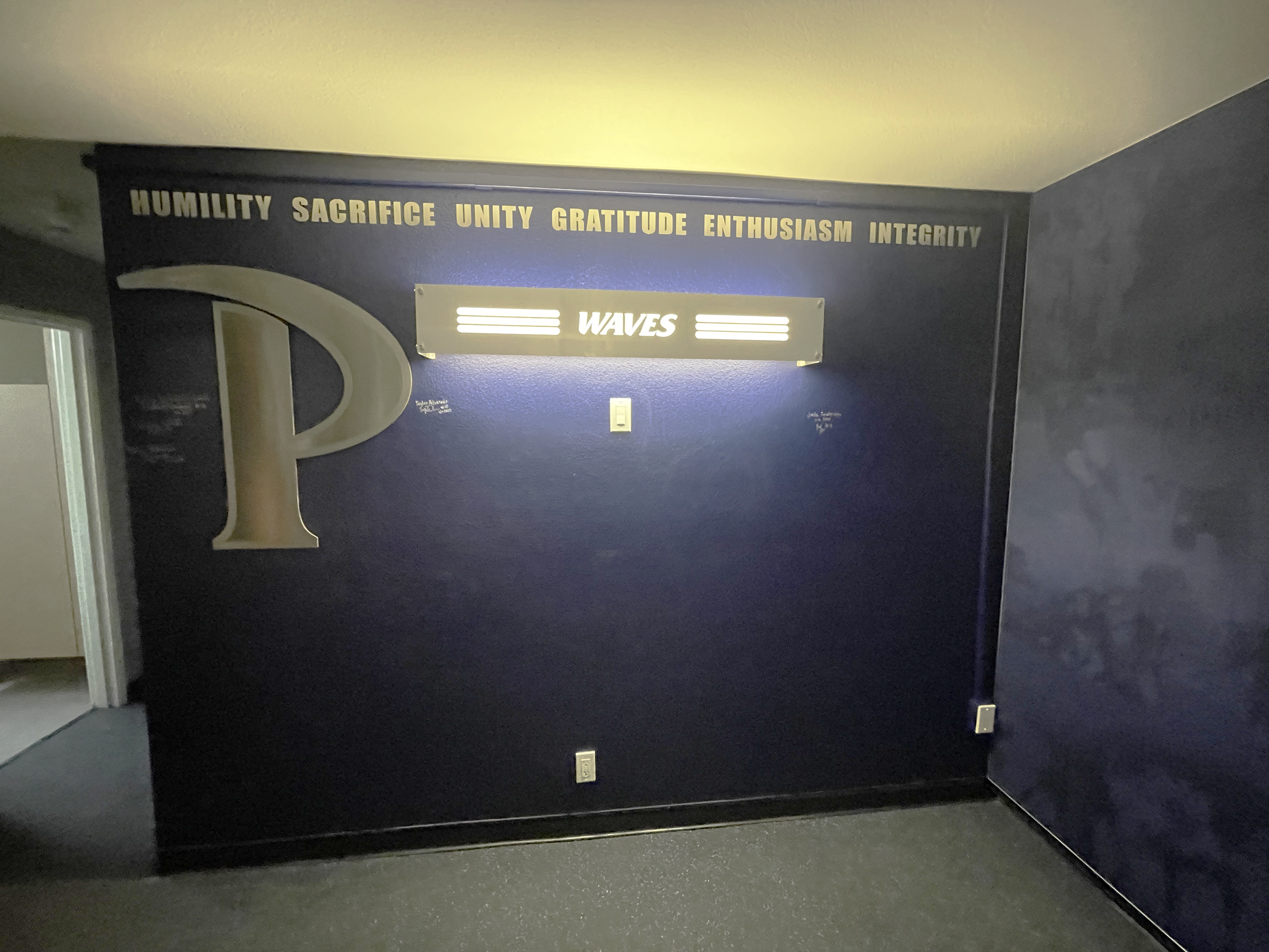 Women's soccer locker room signature wall