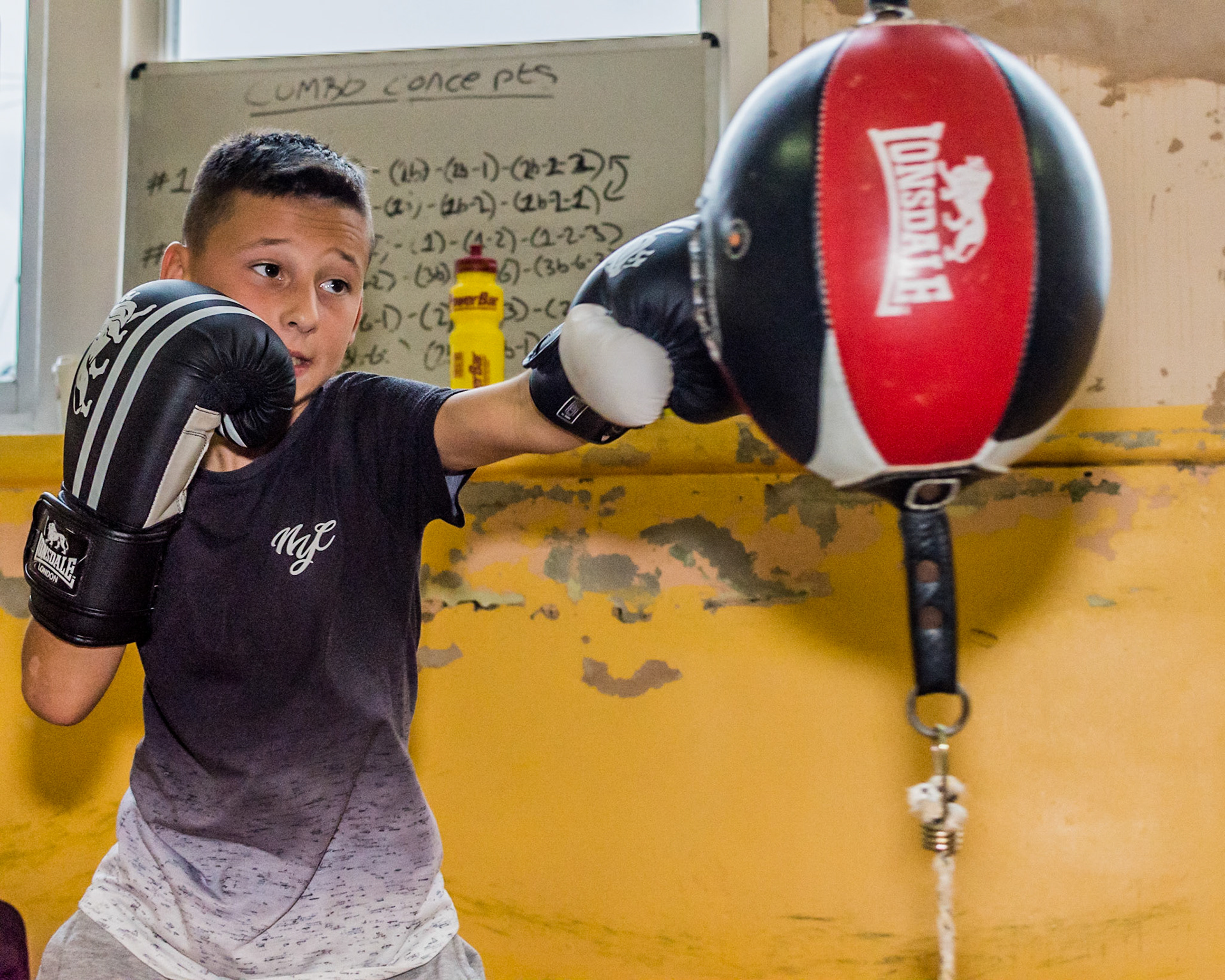 Young Boxer boxing training on the floor to ceiling ball.