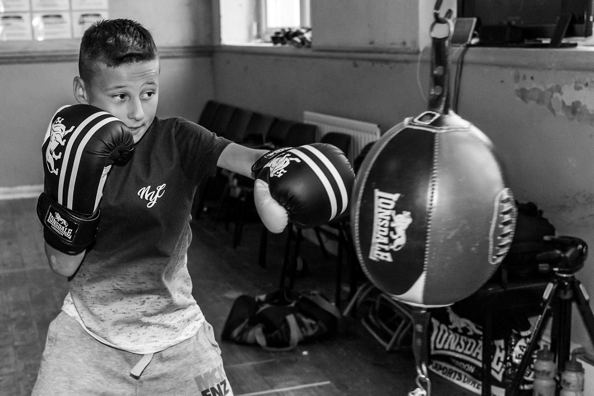 Young Boxer boxing training on the floor to ceiling ball.