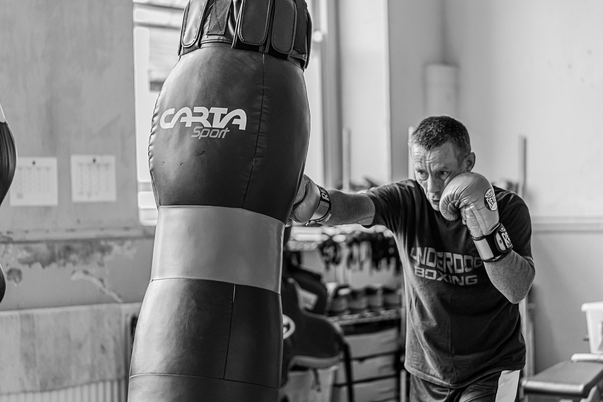 Head coach CoachFoxy Boxing training on the heavy bag. Landing a rear hand straight shot.