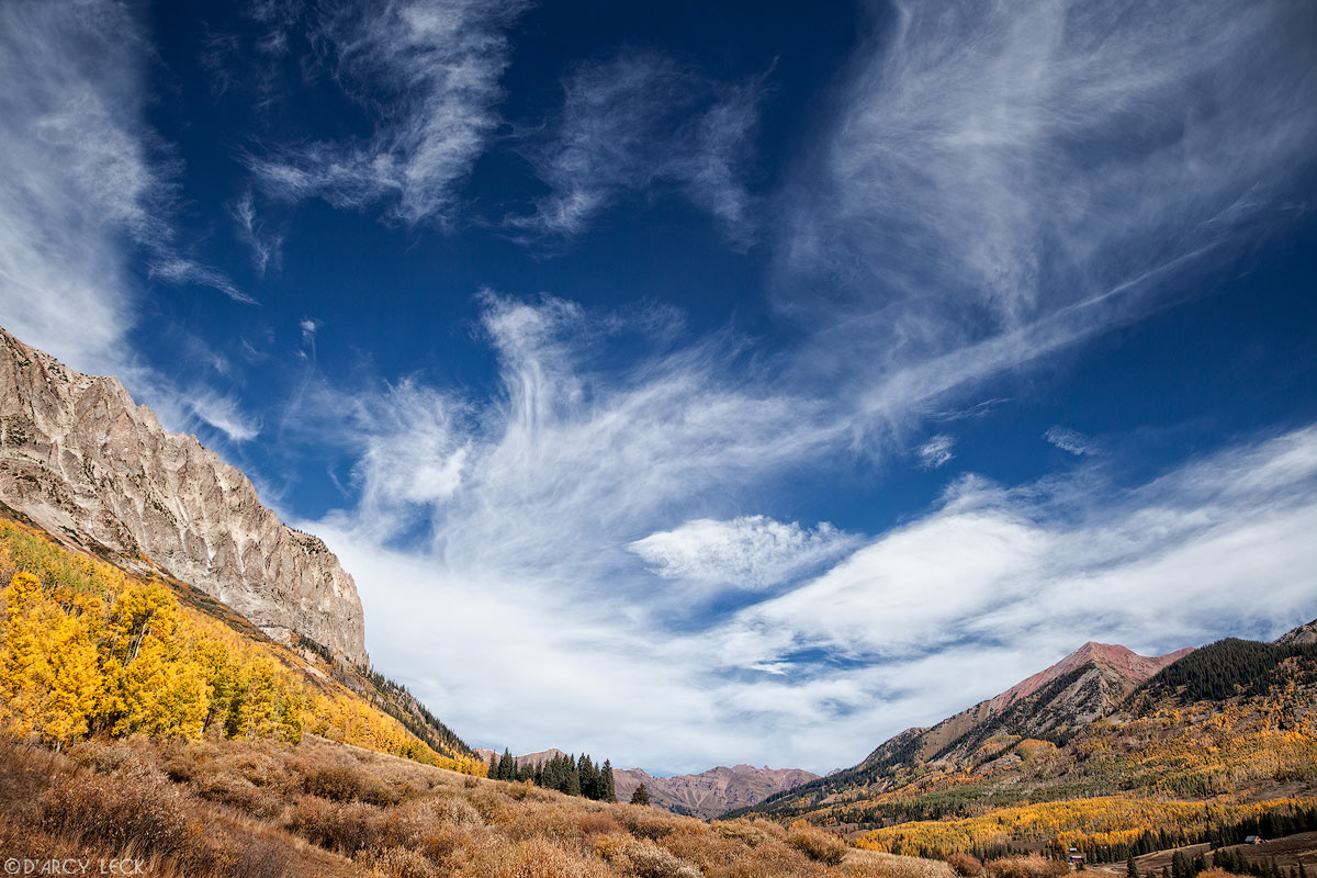 Cirrus clouds drift over East River Valley and Gothic Mountain in early Autumn, Colorado